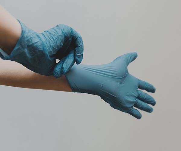 Hands putting on gloves