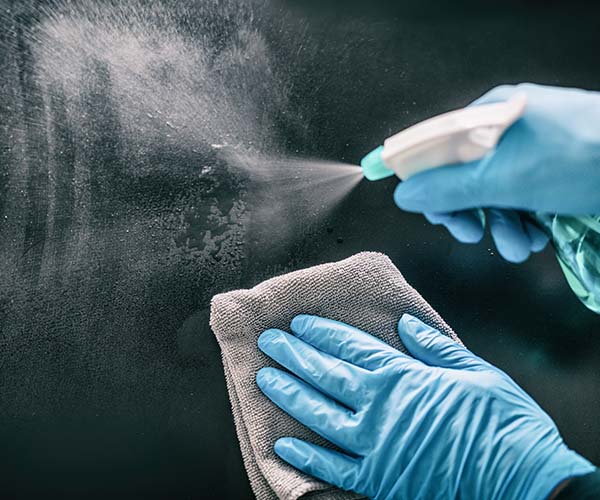 Spraying cleaning products on glass