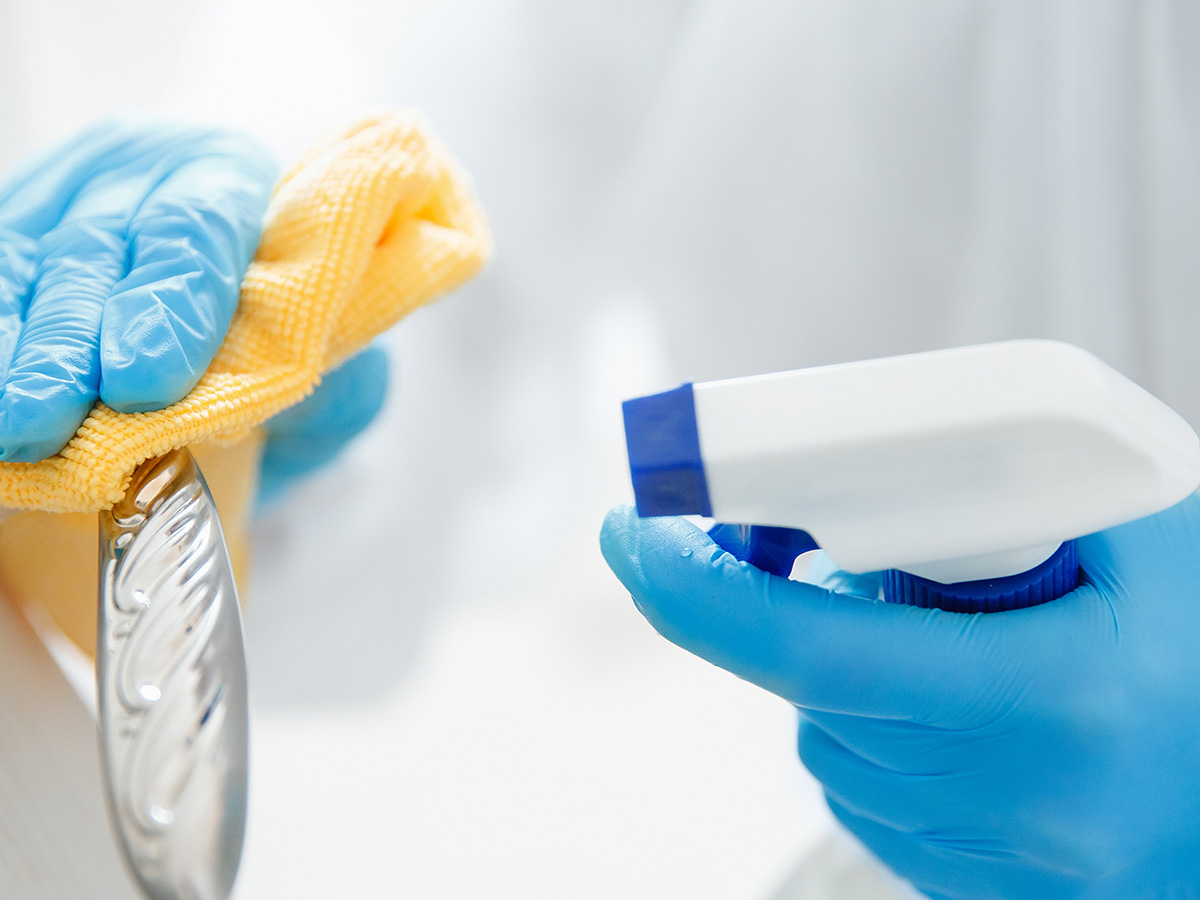 Image of a cleaner wiping off a door handle
