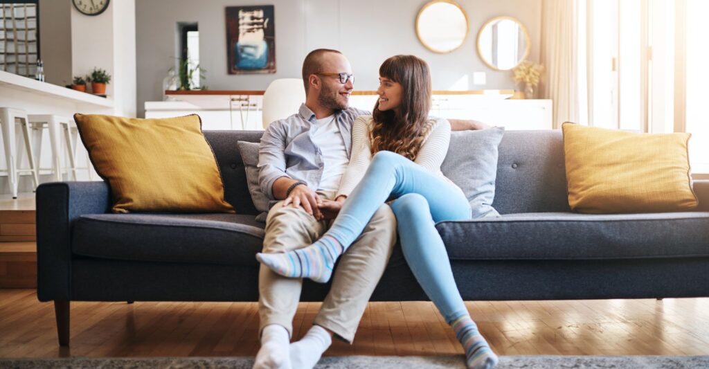 Image of a couple sitting on a couch.