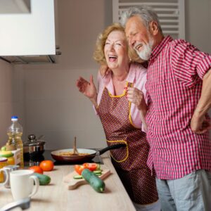 happy couple making dinner in their clean kitchen