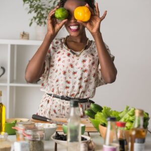 Impress your guests with Best House Cleaning Company woman  holding up fruit in a playful way