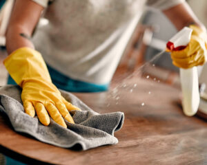 House cleaning company wiping down a counter