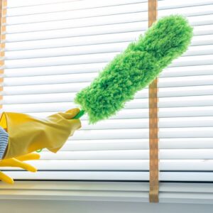 Housekeeping Service dusting blinds. 