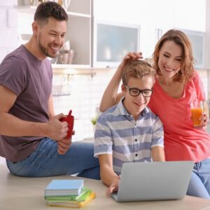 Mom and Dad doing homework with their son.